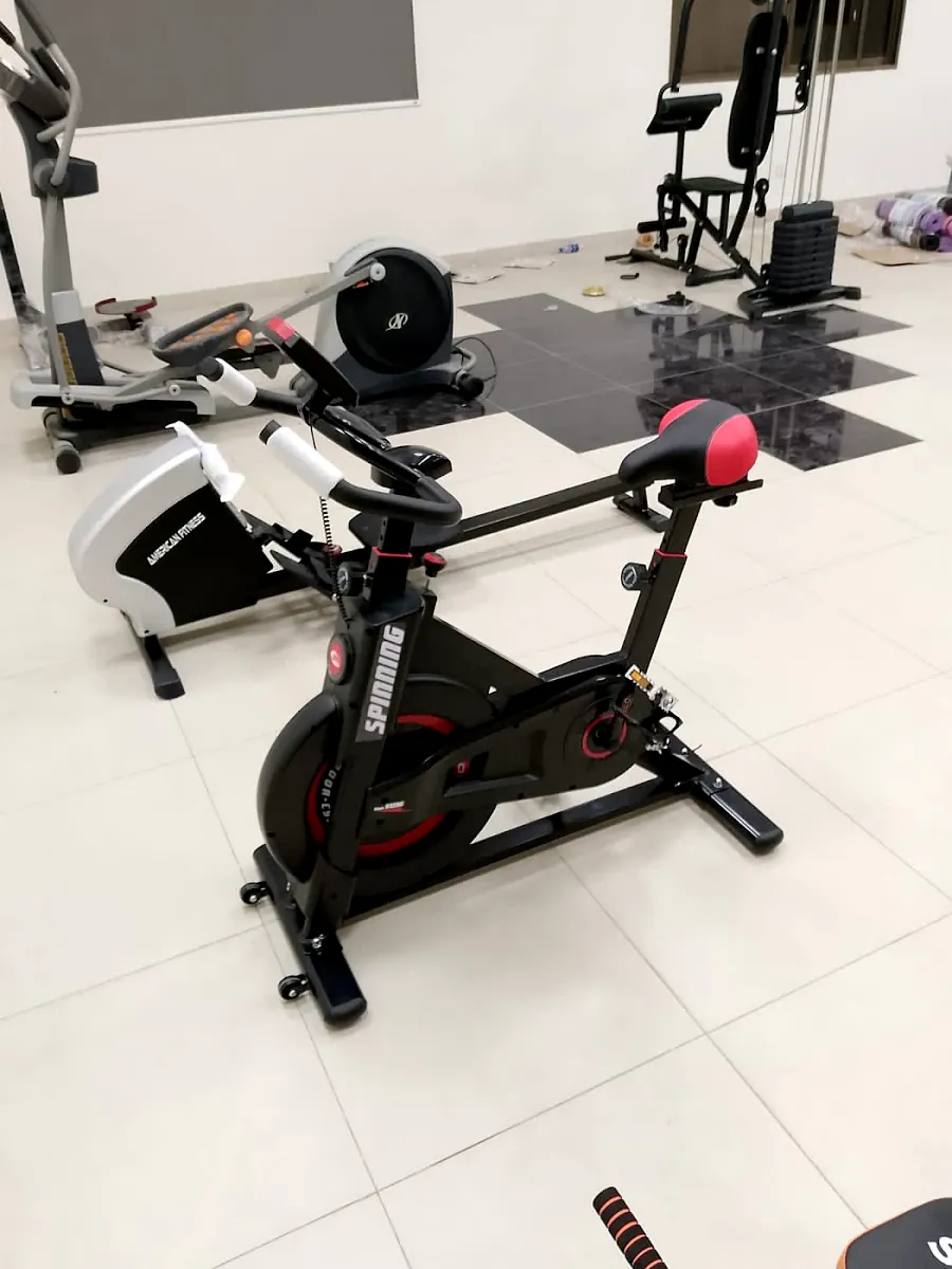 A spin bike and rower in a home gym the shop delivered in DHA